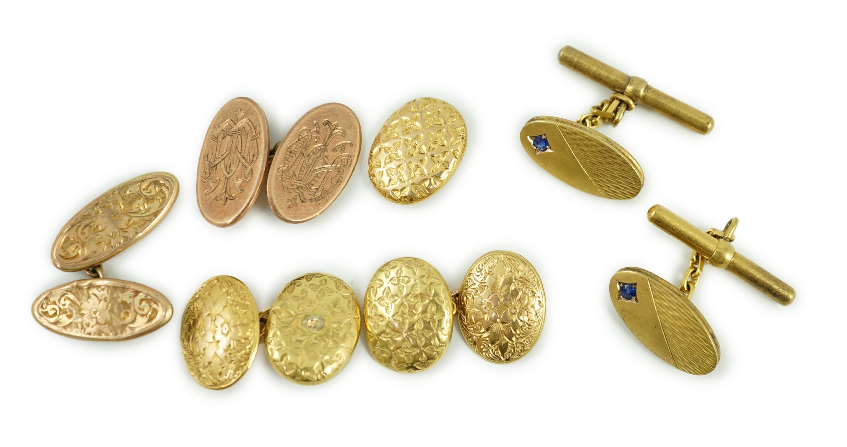 A pair of late Victorian engraved 15ct gold oval cufflinks, one other similar link section only, 6.7 grams, a pair of gem set 585 cufflinks, gross 6.5 grams and two 9ct gold cufflinks, 5.9 grams.